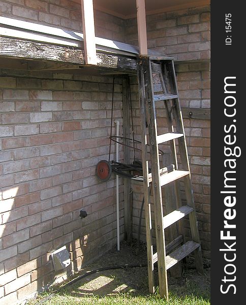 A ladder and some other stuff leaning up against the outside of my grandfather's house. A ladder and some other stuff leaning up against the outside of my grandfather's house.