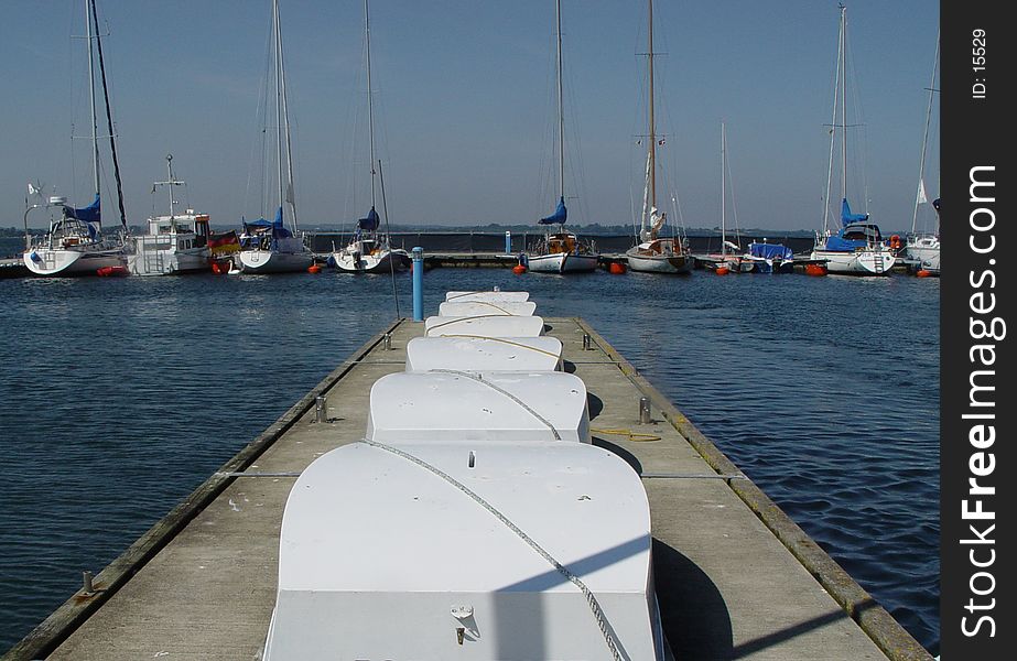 rowing boats on a pier in a yachting club. rowing boats on a pier in a yachting club