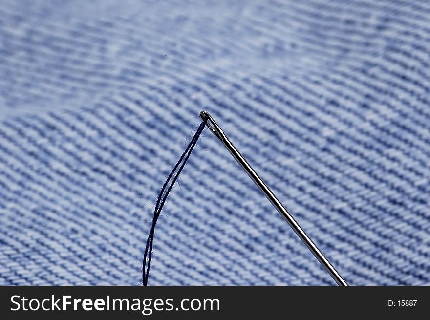 Photo of Sewing Needle and Denim Fabric