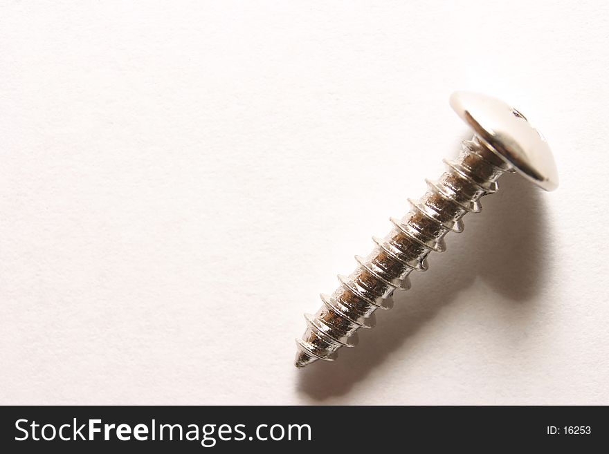 Close-up photo of a metal screw. Close-up photo of a metal screw.