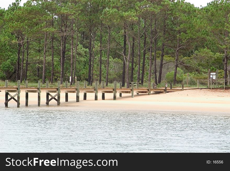 Walkway leading to dry land from the pier on Cape Lookout, North Carolina. Photo taken at low tide. Walkway leading to dry land from the pier on Cape Lookout, North Carolina. Photo taken at low tide