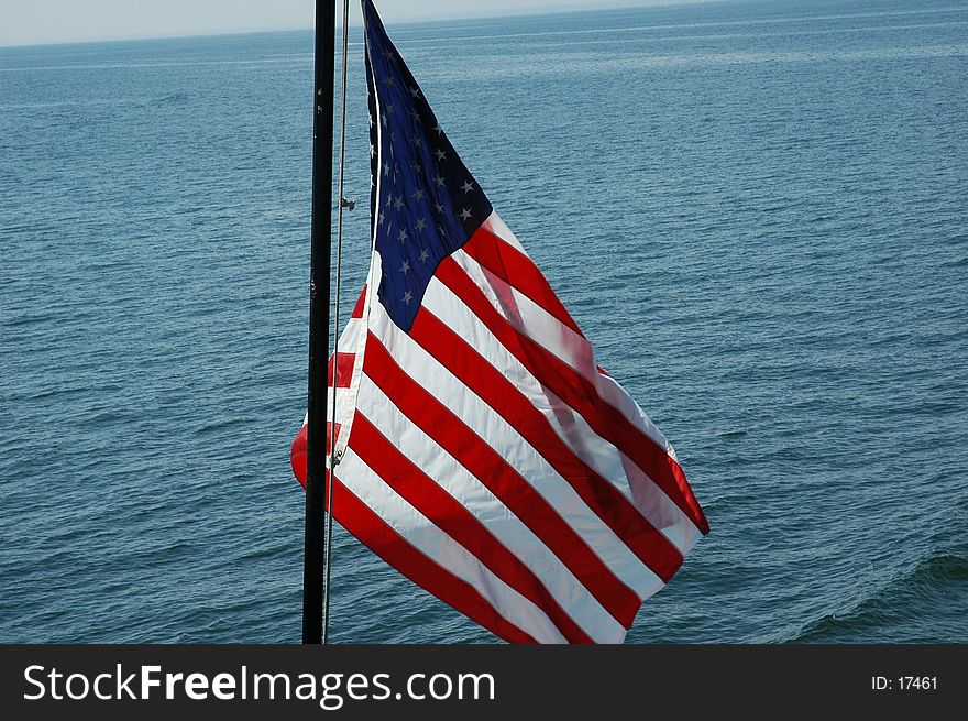 Flag waving in the wind out on Long Island Sound. Flag waving in the wind out on Long Island Sound.