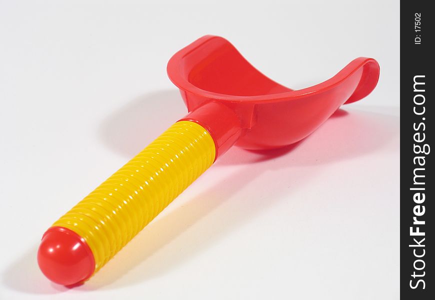 Haft of a yellow-colored and red-colored sandbox toy shovel. Haft of a yellow-colored and red-colored sandbox toy shovel.