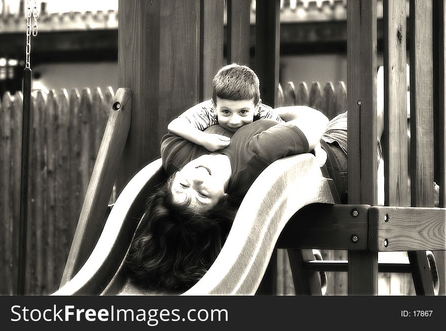 Photo of Mother and Child on Slide In Black and White With Blur Type Effect. Photo of Mother and Child on Slide In Black and White With Blur Type Effect
