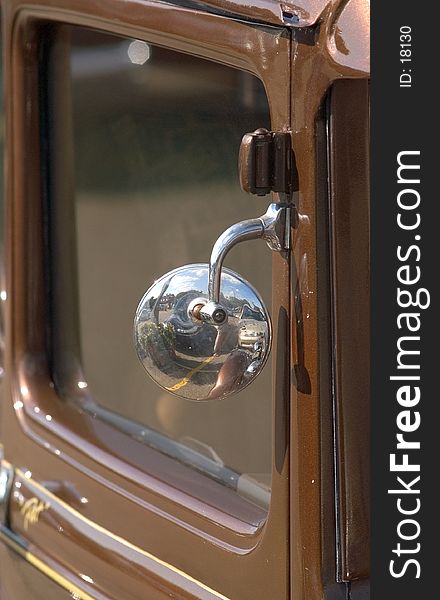 Detail of an antique car focusing on the side mirror. Detail of an antique car focusing on the side mirror.