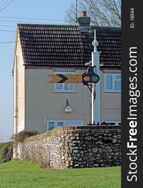 Restored old British railway yellow caution signal ( UK term: distant ) in the back garden of a house in Norfolk, England. Restored old British railway yellow caution signal ( UK term: distant ) in the back garden of a house in Norfolk, England.