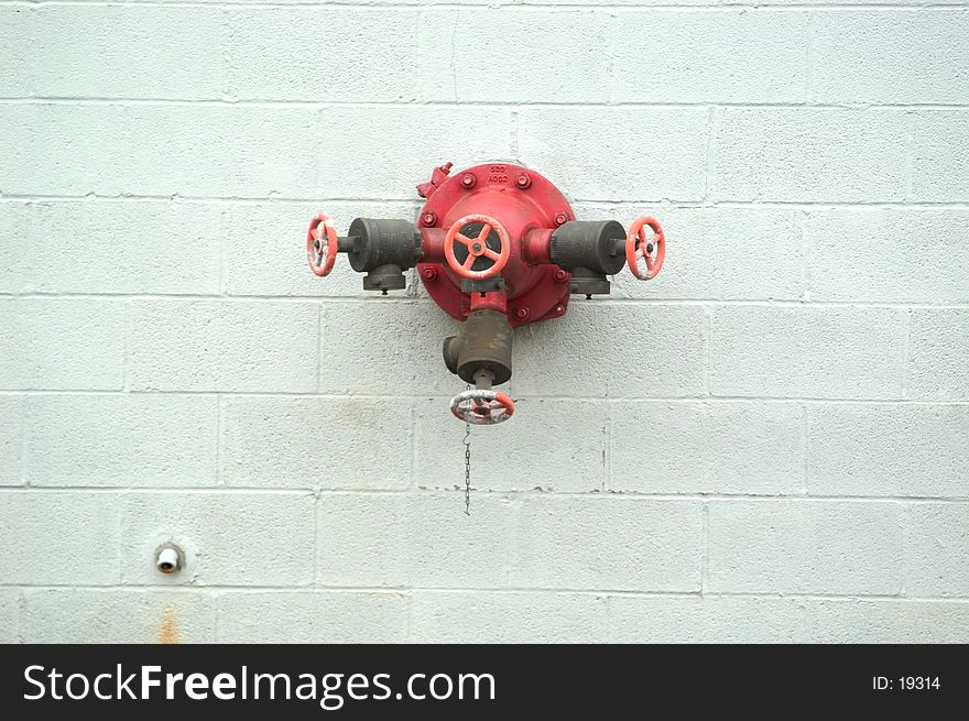 A connector on an industrial building for fire hoses. Supply of water in case of a fire. A connector on an industrial building for fire hoses. Supply of water in case of a fire