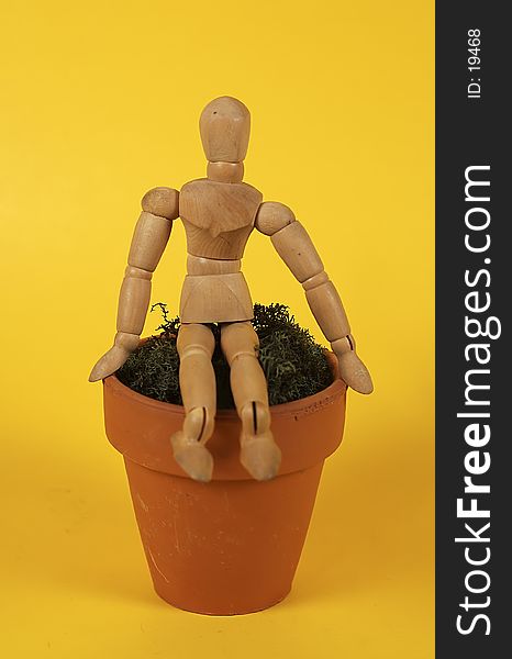 Photo of Mannequin Sitting on a Ceramic Pot. Photo of Mannequin Sitting on a Ceramic Pot.