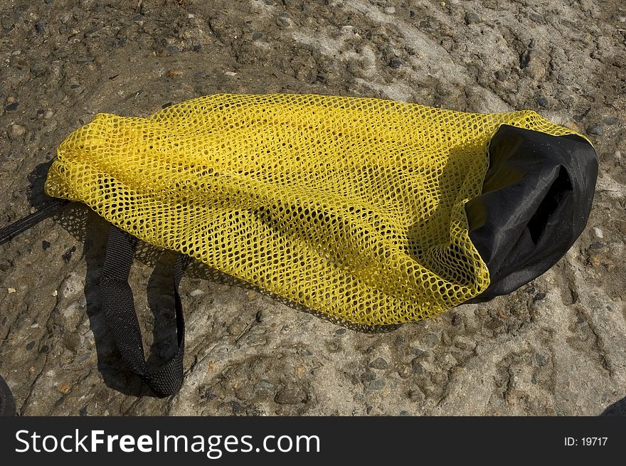 A yellow mesh catch/beach bag. A yellow mesh catch/beach bag