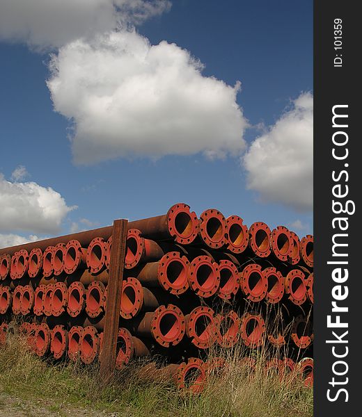 A pile of rusty tubes lying on a meadow...