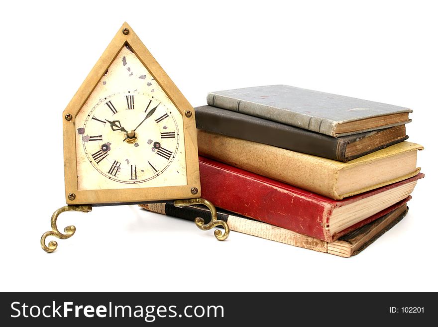 Antique clock with stack of antique books. Antique clock with stack of antique books
