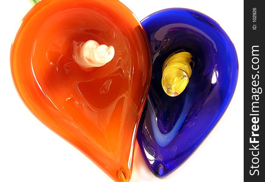 2 orange and purple hand blown glass flowers. 2 orange and purple hand blown glass flowers