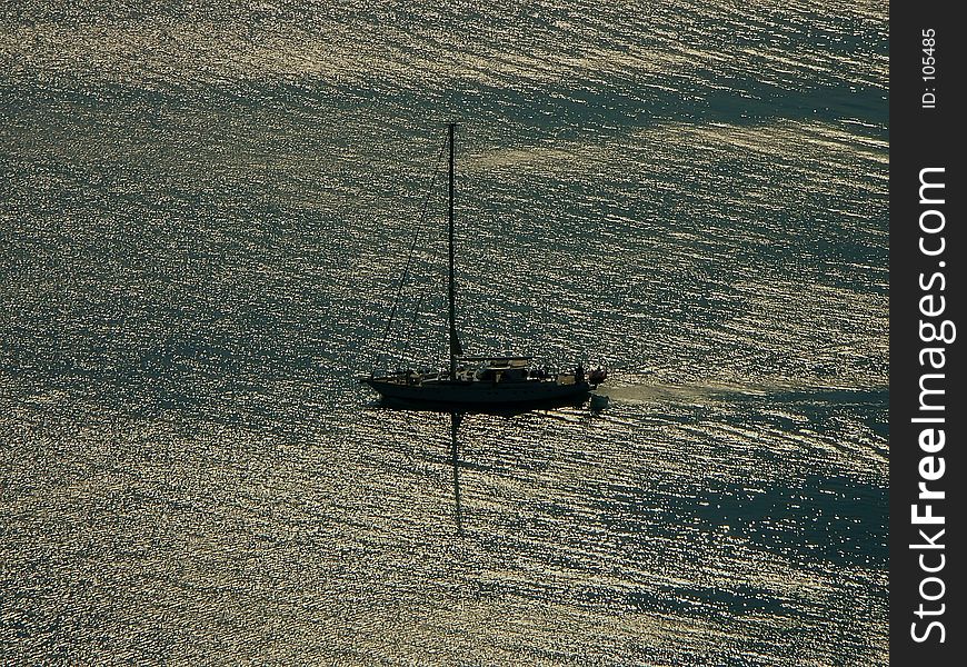 Silhouette of sailing boat in the open sea