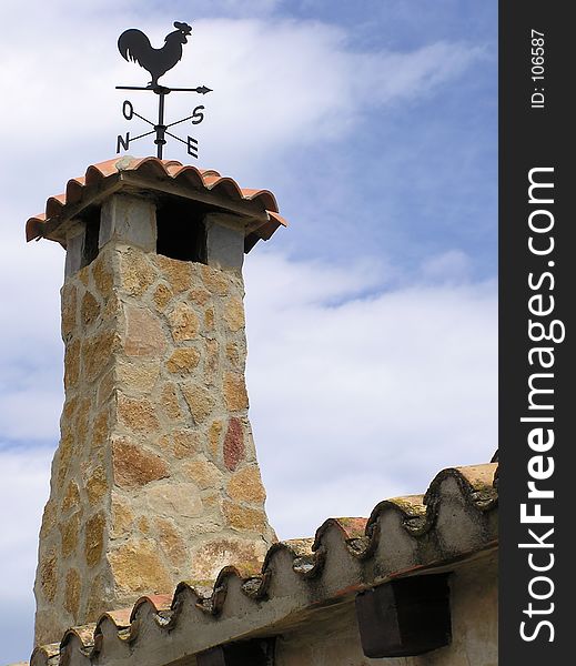 Stone chimney with weathervane. Stone chimney with weathervane