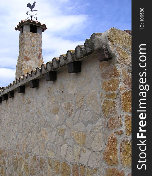 Stone chimney with weathervane. Stone chimney with weathervane
