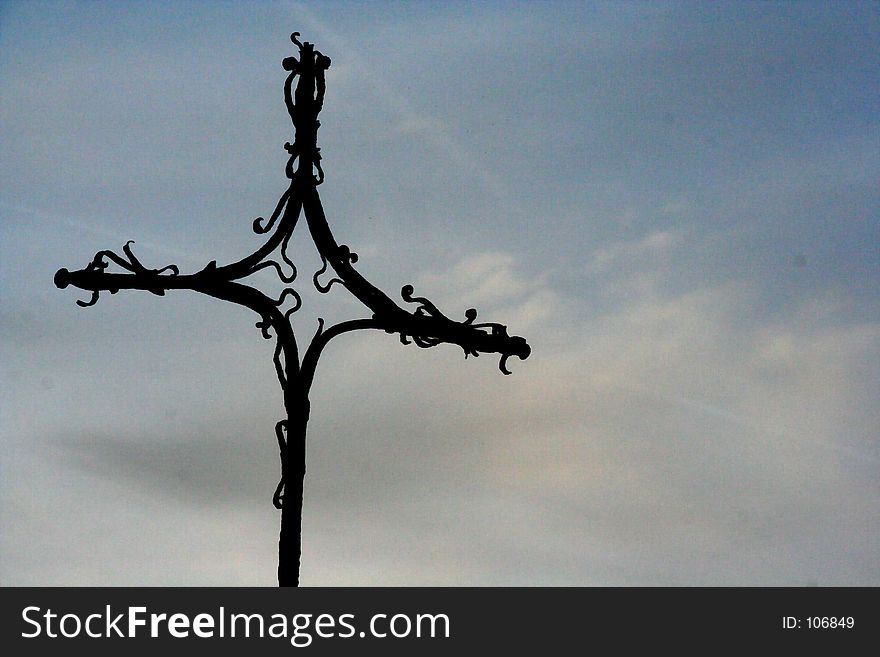 Silhouette of cross against a sunset sky