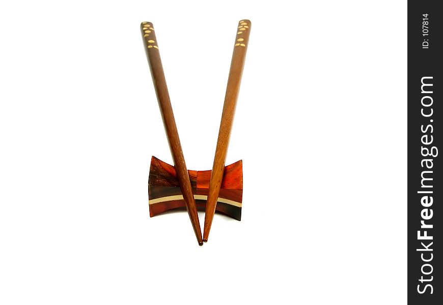 Chopsticks on a support over white background. Chopsticks on a support over white background
