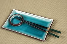 Plate, Dipping Bowl And Chop Sticks On Green Mat Stock Images Plate, Dipping Bowl And Chop Sticks On Green Mat Stock Images