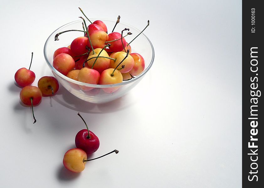 Clear glass bowl full of Ranier cherries. Clear glass bowl full of Ranier cherries