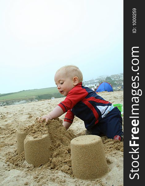 Small child exploring a beach in Cornwall. Small child exploring a beach in Cornwall.