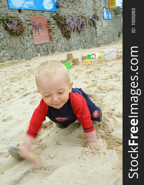 Small child exploring a beach in Cornwall. Small child exploring a beach in Cornwall.