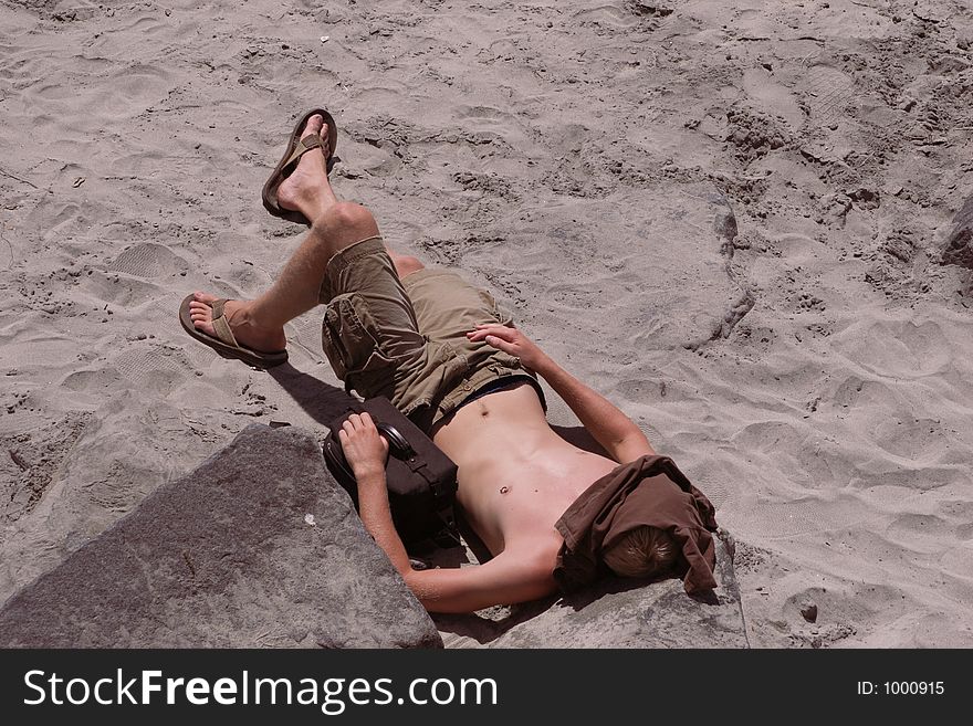 Young man sleeping on the beach. Young man sleeping on the beach