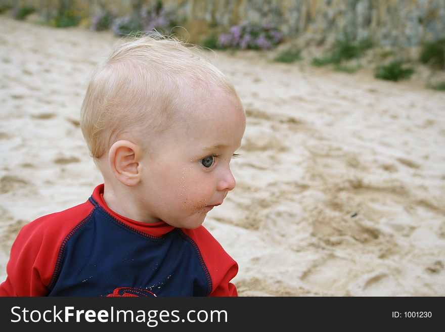 Small child exploring a beach in Cornwall. Small child exploring a beach in Cornwall.