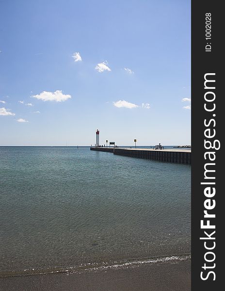 Clear beach water by lighthouse at Whitby, Ontario