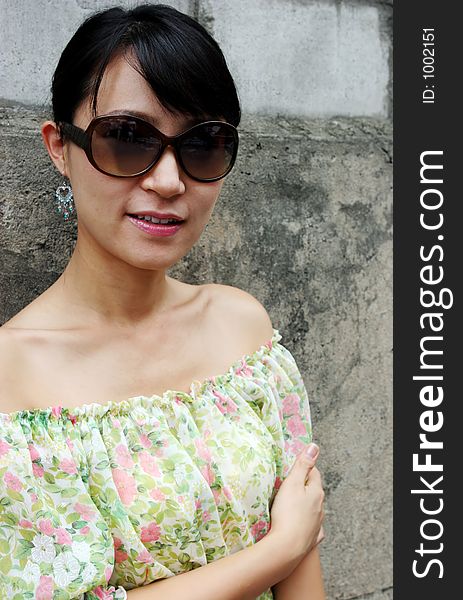 Portrait of a pretty Asian woman wearing big shades