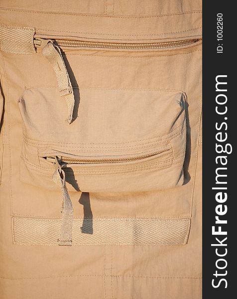 Beige sport trousers with pokets and zippers. Beige sport trousers with pokets and zippers