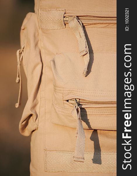 Beige sport trousers with pokets and zippers. Beige sport trousers with pokets and zippers