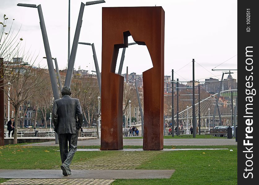 Statue of man walking in Bilbao