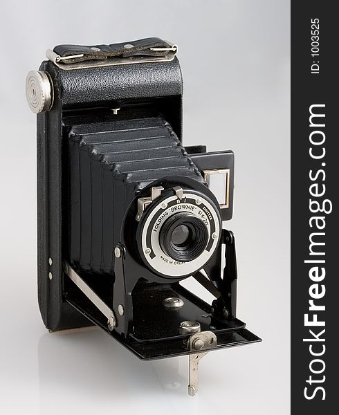 Old black photo camera on white