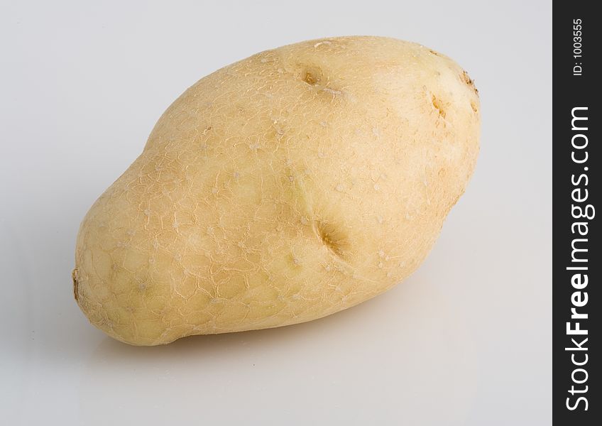 Light brown potato on white