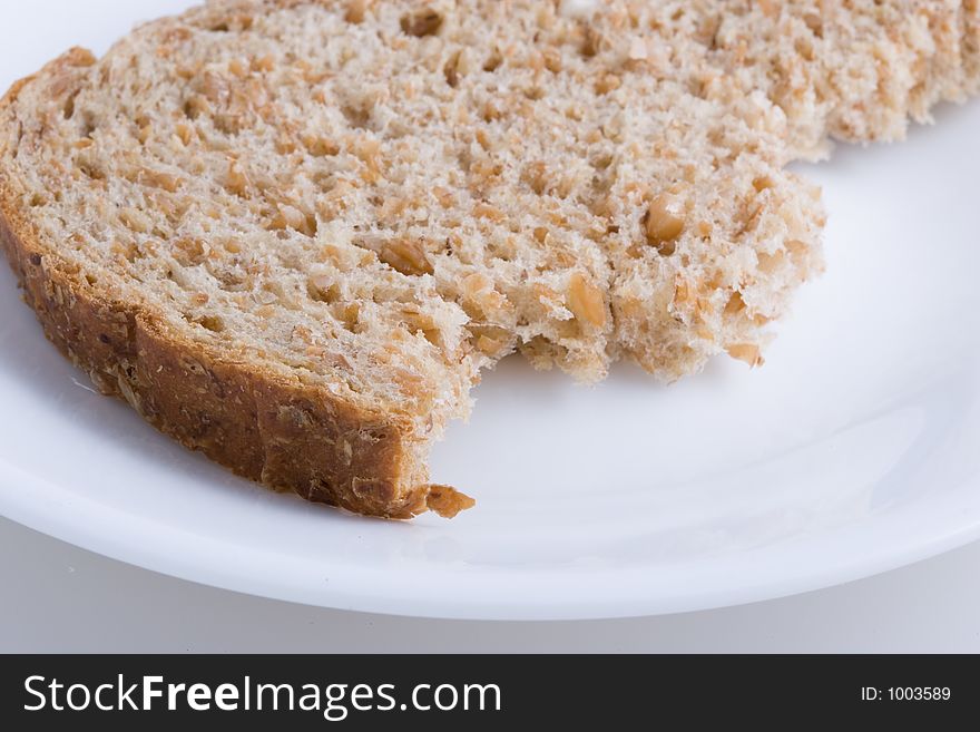 Piece of bread on white plate