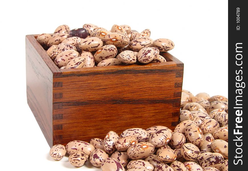 Spotted beans and a wooden cup, isolated over white background. Spotted beans and a wooden cup, isolated over white background.