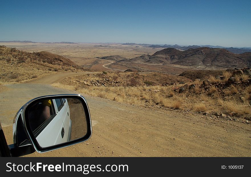 Car mirror and great desert landscape