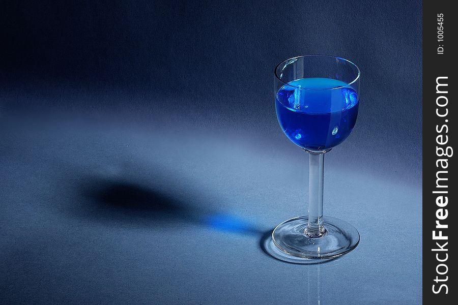 Liqueur glass on blue background