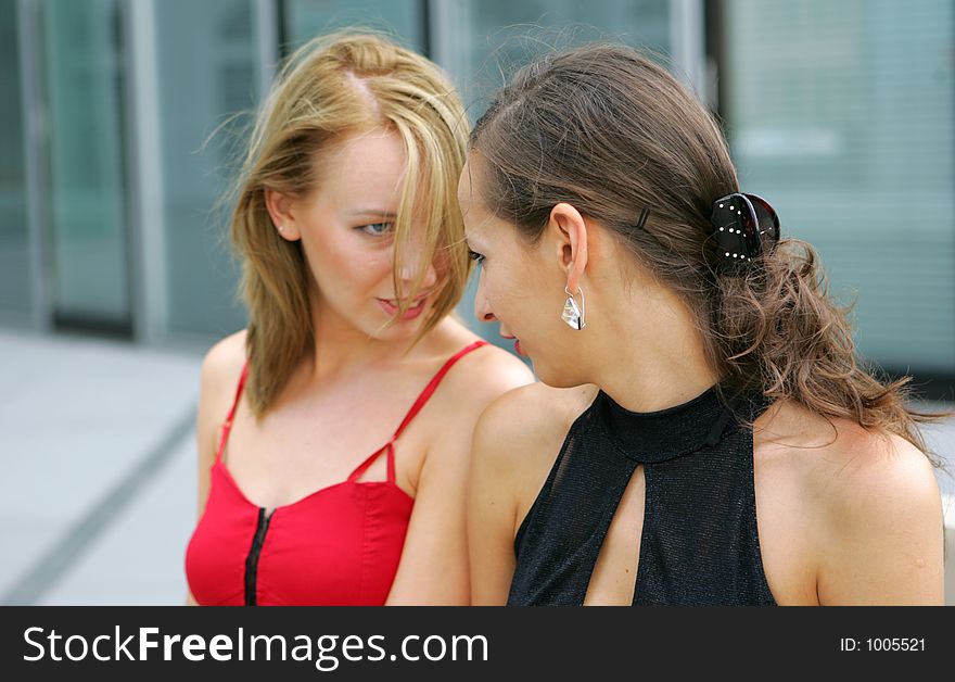 Two models on the street looking at each other. Two models on the street looking at each other