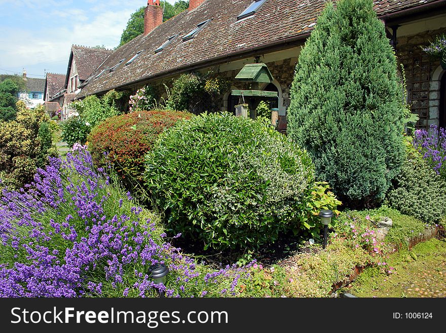 A row of renovated medieval cottages, swamped by gardens. A row of renovated medieval cottages, swamped by gardens