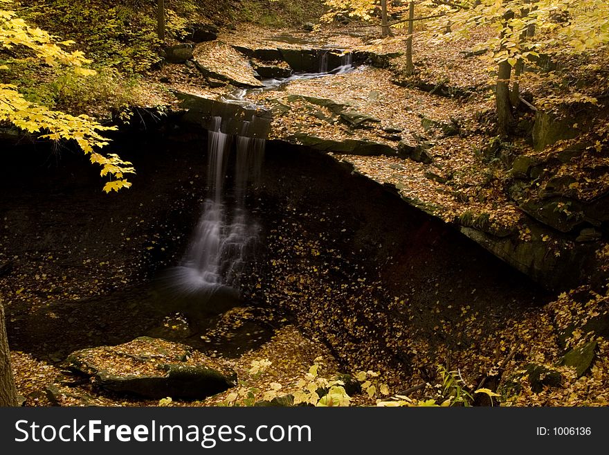 A beautiful cascading waterfall with fall colors. A beautiful cascading waterfall with fall colors