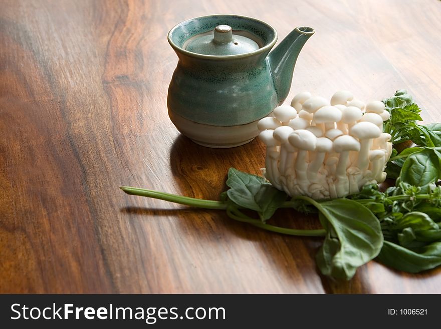 Ingredients sit ready for the Asian cook to prepare a fresh, healthy meal with mushrooms, soy and basil. Focus is on soy pottery container. Ingredients sit ready for the Asian cook to prepare a fresh, healthy meal with mushrooms, soy and basil. Focus is on soy pottery container.