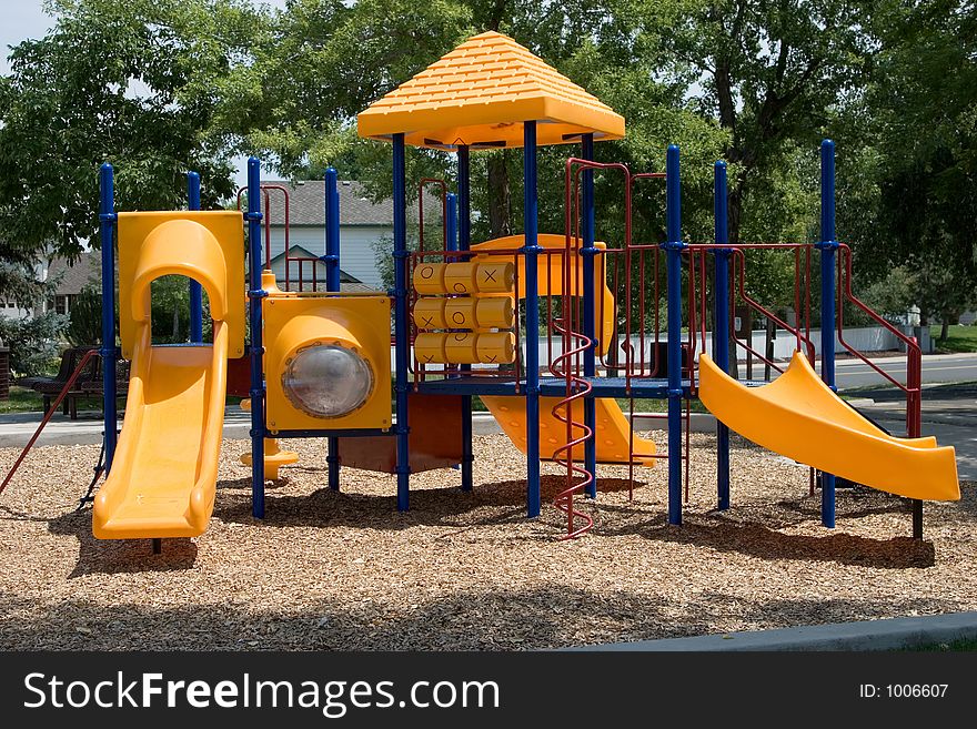 A playground built for young kids in primary colors of red, blue and yellow. A playground built for young kids in primary colors of red, blue and yellow.