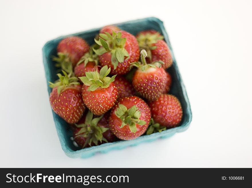 A quart of fresh strawberries from above.