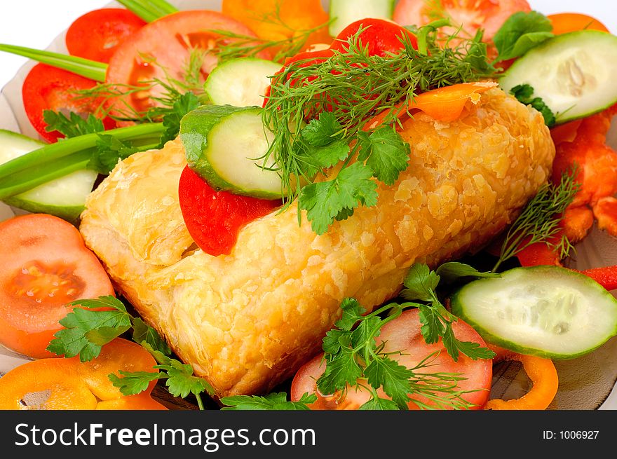 Appetizing meat pie with vegetables dish close-up