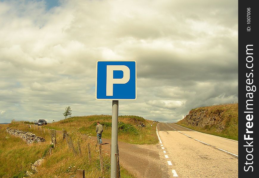 Man taking a break in a layby during a long drive. Man taking a break in a layby during a long drive.