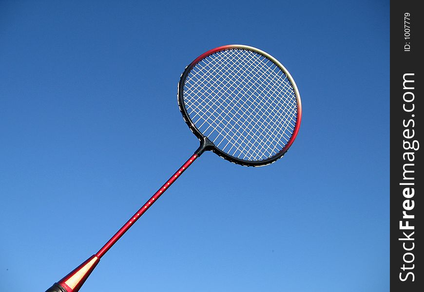 Badminton racket on the blue sky background