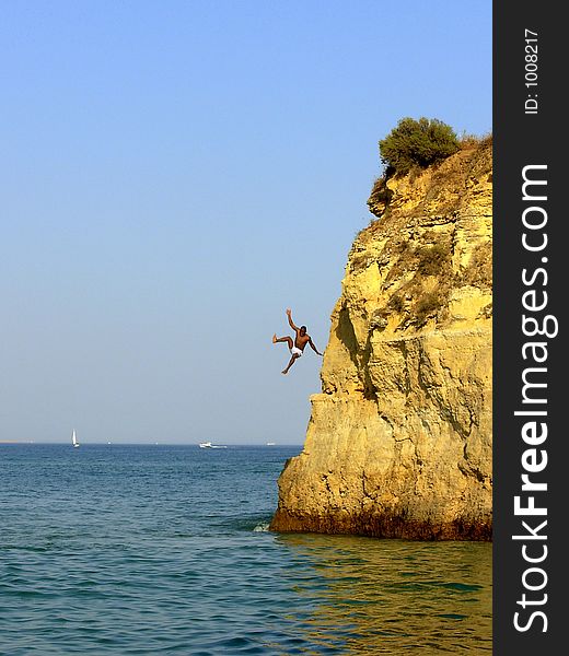 Swimmer in the Batata beach in Algarve Lakes training of fast form divings for the sea. Swimmer in the Batata beach in Algarve Lakes training of fast form divings for the sea.