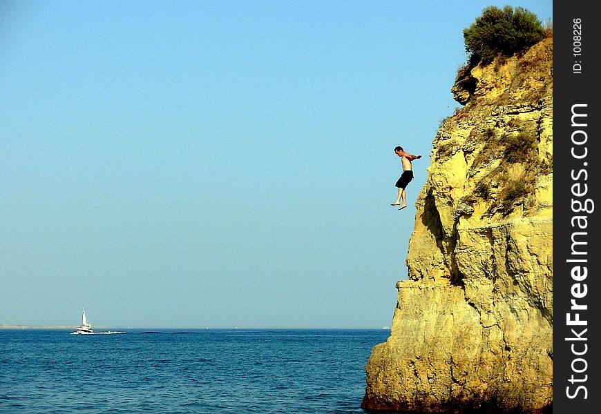 Swimmer in the Batata beach of the Potato in Algarve Lakes(Lagos) training of fast form divings for the sea. Swimmer in the Batata beach of the Potato in Algarve Lakes(Lagos) training of fast form divings for the sea.