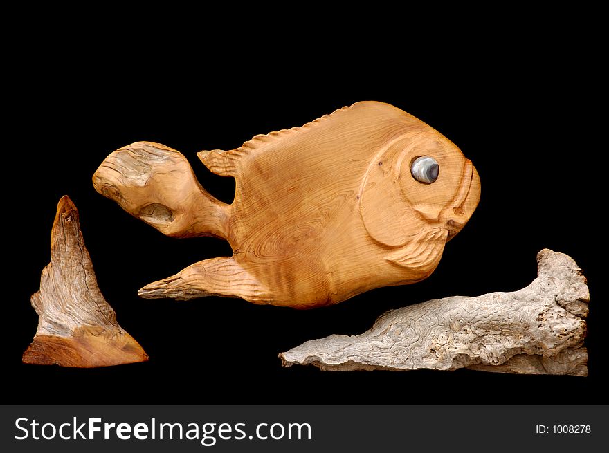 Decorative fish made of wood isolated on black background. Decorative fish made of wood isolated on black background